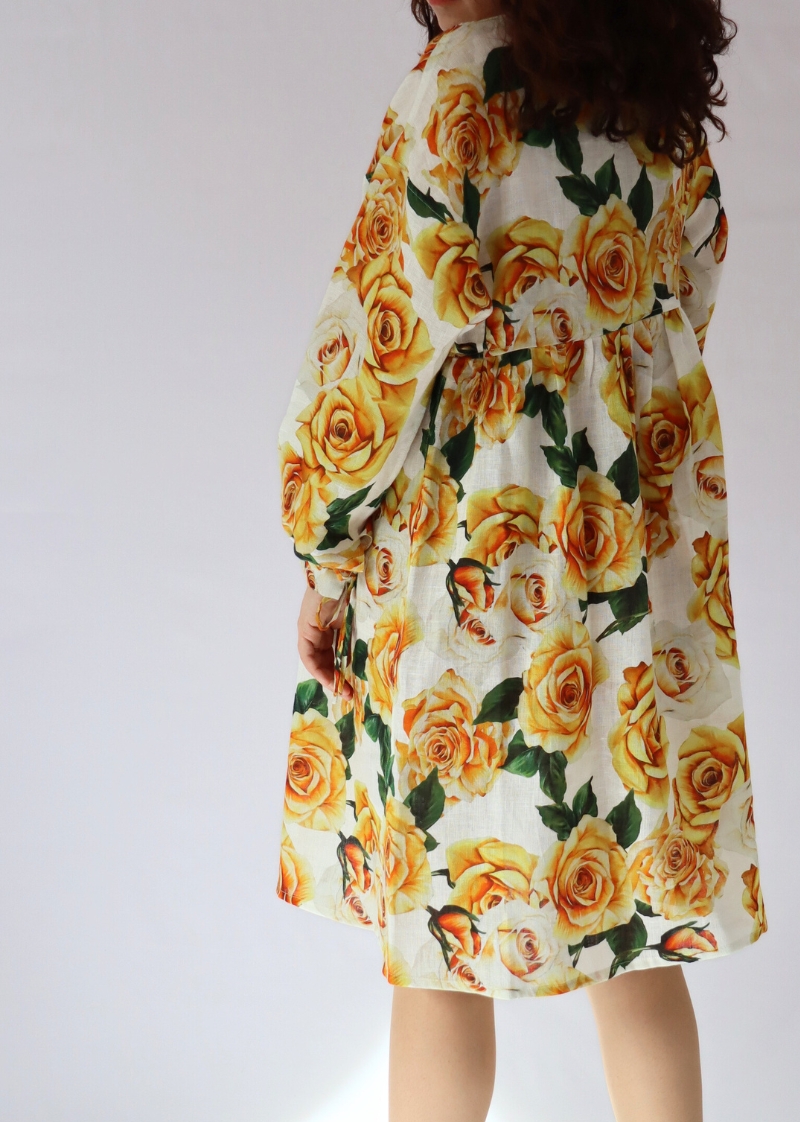 Back detail of the golden rose linen dress with kimono sleeves and tied cuffs