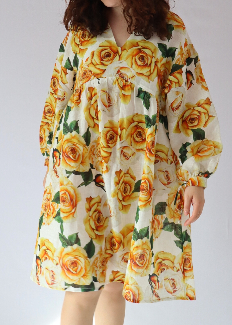 Detailed look at tied cuffs and soft drape of the golden rose linen dress made from Italian linen