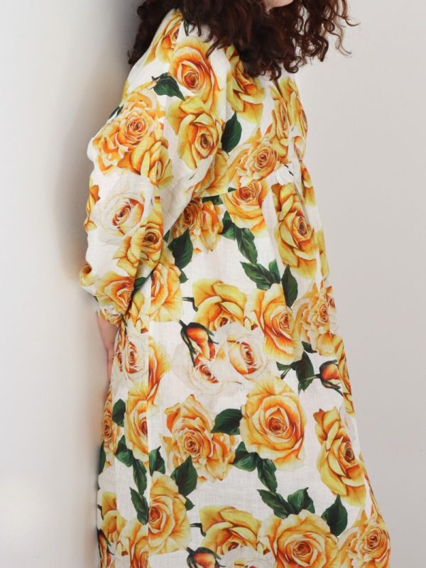Side view of golden rose linen dress showing the lowered armscye and kimono sleeve design
