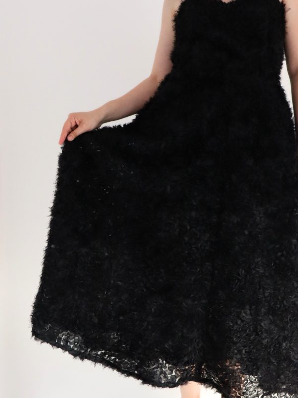 Detail of sweetheart neckline on timeless midi black dress with embroidered tulle