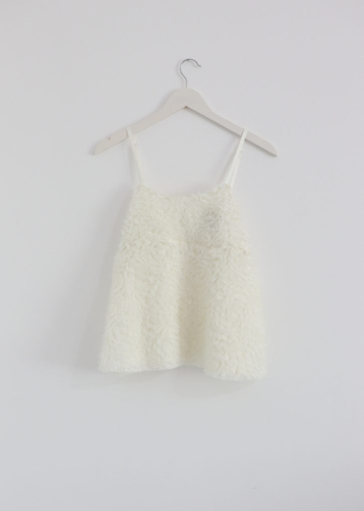 Elegant white tulle top with airy embroidered details, perfect for a feminine look