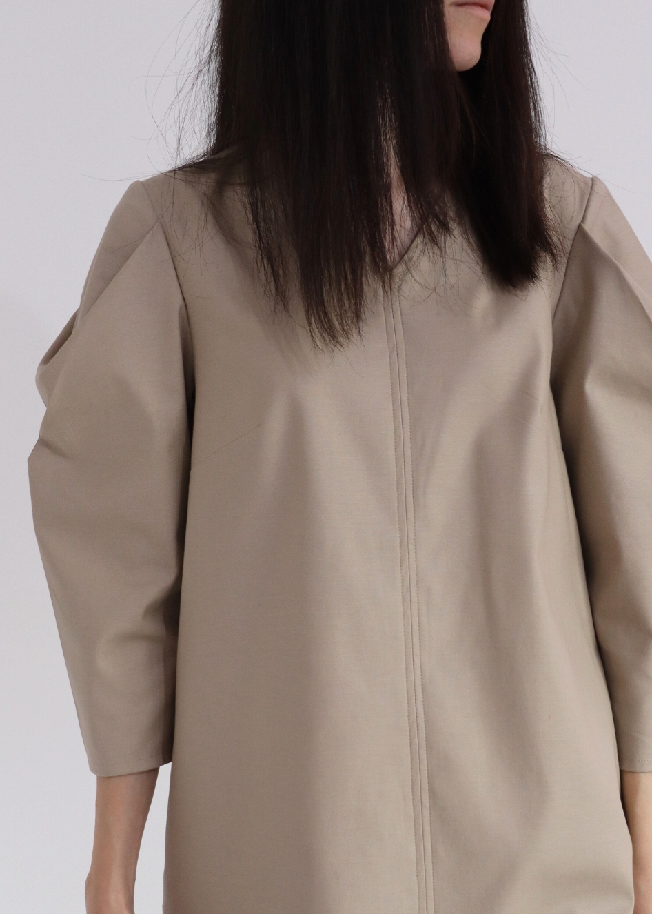 Front view of HERET beige cotton fall dress with relaxed fit and long sleeves